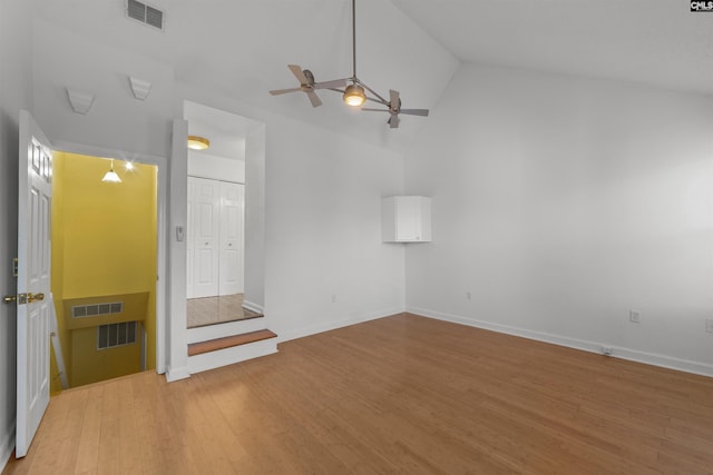 empty room featuring high vaulted ceiling, hardwood / wood-style floors, and ceiling fan