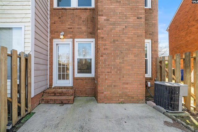 doorway to property with a patio and central air condition unit