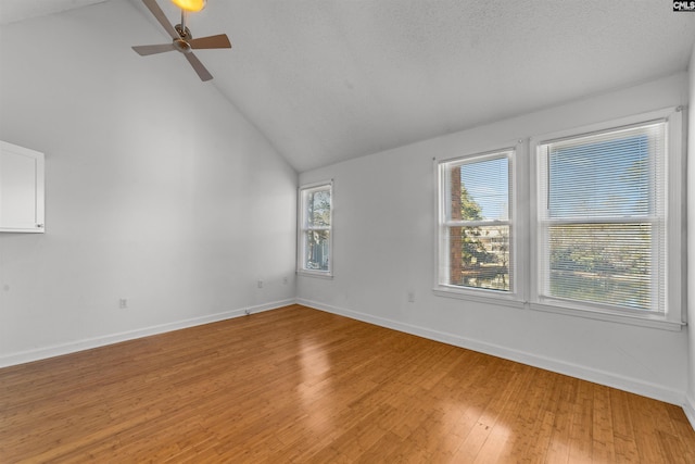 unfurnished room featuring a textured ceiling, light hardwood / wood-style flooring, high vaulted ceiling, and ceiling fan