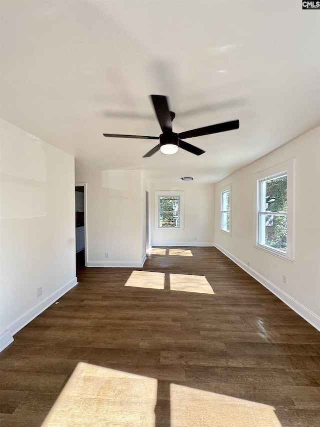 unfurnished room with dark hardwood / wood-style floors and ceiling fan