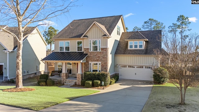 view of front of property with a garage, a porch, and a front lawn