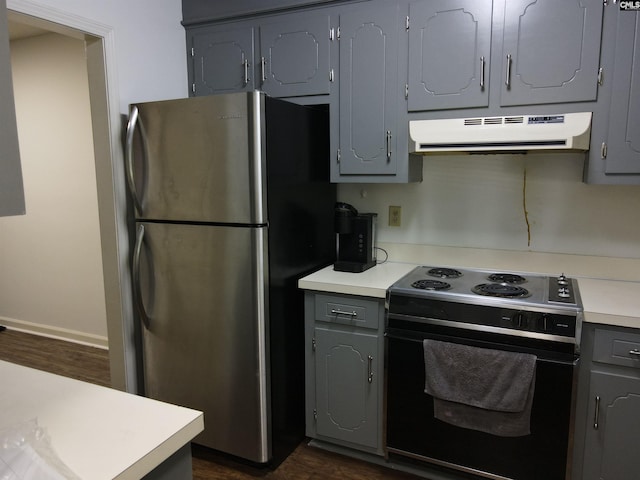 kitchen featuring black / electric stove, gray cabinetry, dark wood-type flooring, and stainless steel refrigerator