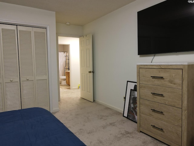unfurnished bedroom featuring light colored carpet and a closet