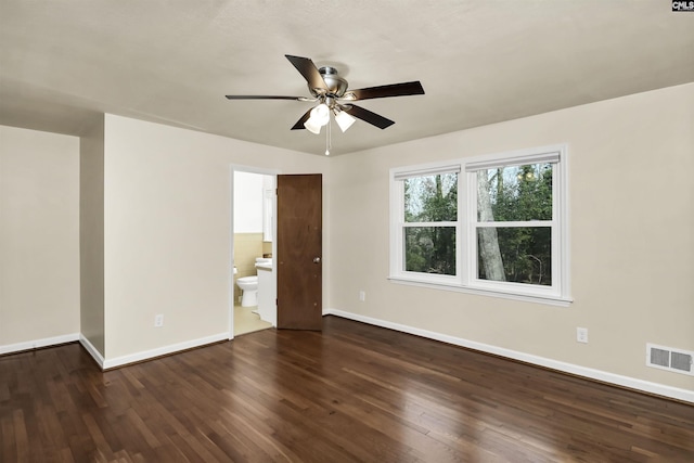 empty room featuring dark wood-type flooring and ceiling fan