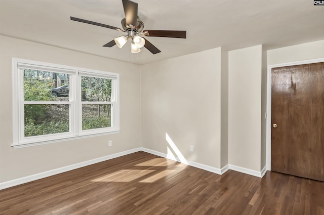 spare room featuring ceiling fan and dark hardwood / wood-style flooring