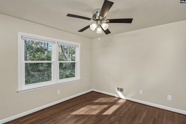 empty room featuring dark hardwood / wood-style flooring and ceiling fan