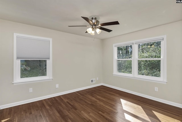 spare room with dark wood-type flooring and ceiling fan