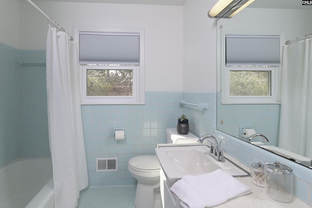 full bathroom featuring tile walls, vanity, toilet, and shower / bathtub combination with curtain