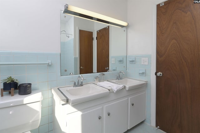 bathroom featuring vanity, tile walls, and toilet