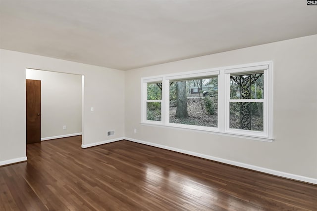 spare room with dark hardwood / wood-style floors