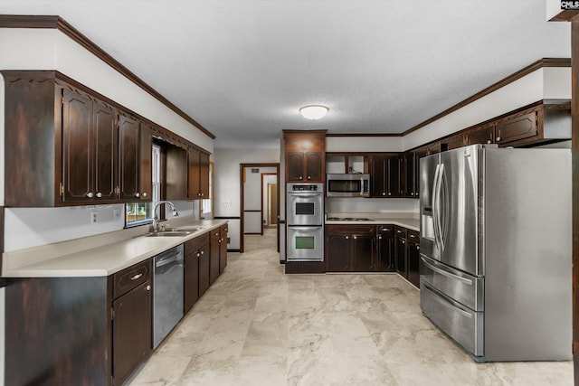 kitchen featuring dark brown cabinetry, sink, crown molding, and appliances with stainless steel finishes