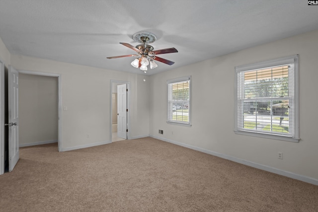 spare room with light carpet and ceiling fan