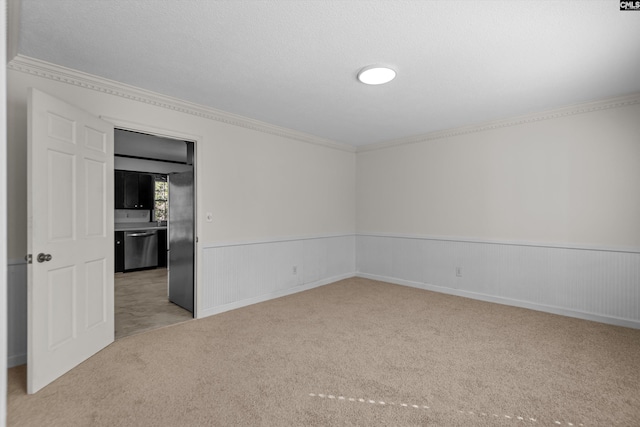 carpeted spare room with crown molding and a textured ceiling