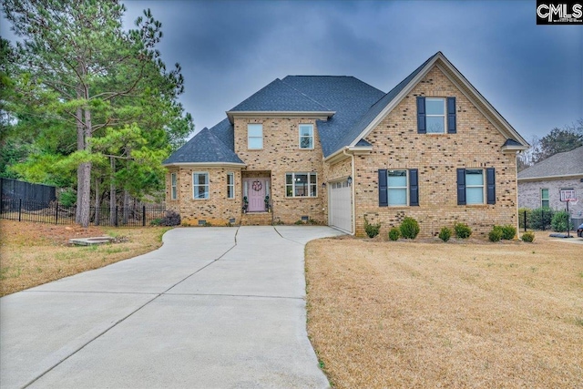 view of front of property featuring a garage and a front yard