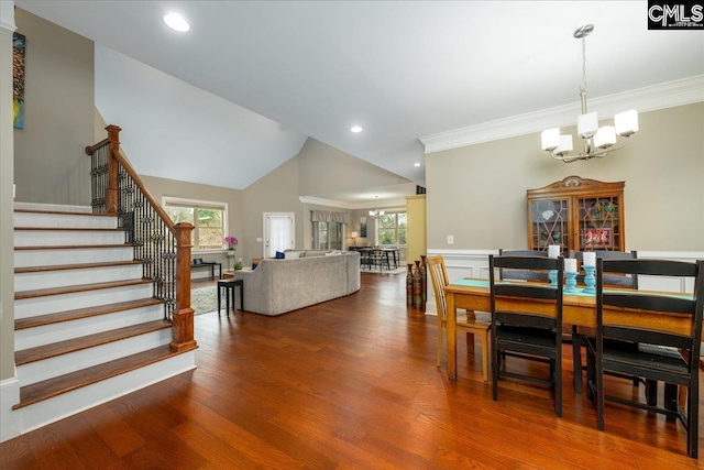 dining room featuring hardwood / wood-style flooring, crown molding, and a notable chandelier