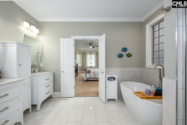 bathroom with vanity, tile patterned flooring, a washtub, and ornamental molding