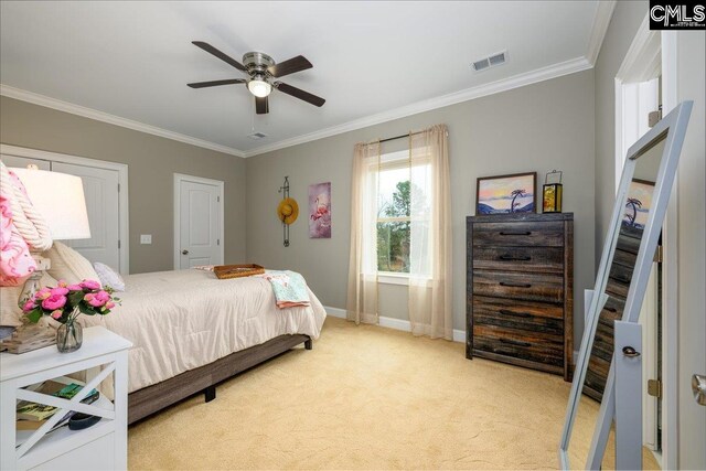 carpeted bedroom with crown molding and ceiling fan