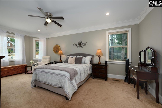 bedroom with crown molding, light colored carpet, and ceiling fan