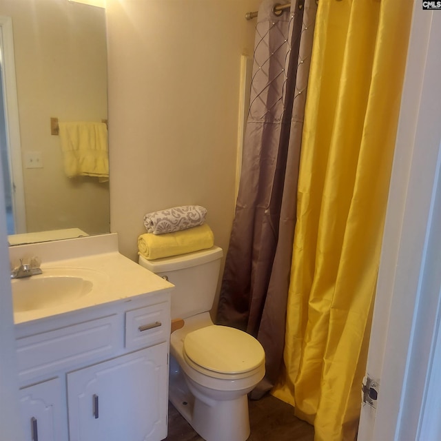 bathroom with vanity, toilet, and a shower with shower curtain