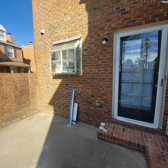 property entrance featuring a patio