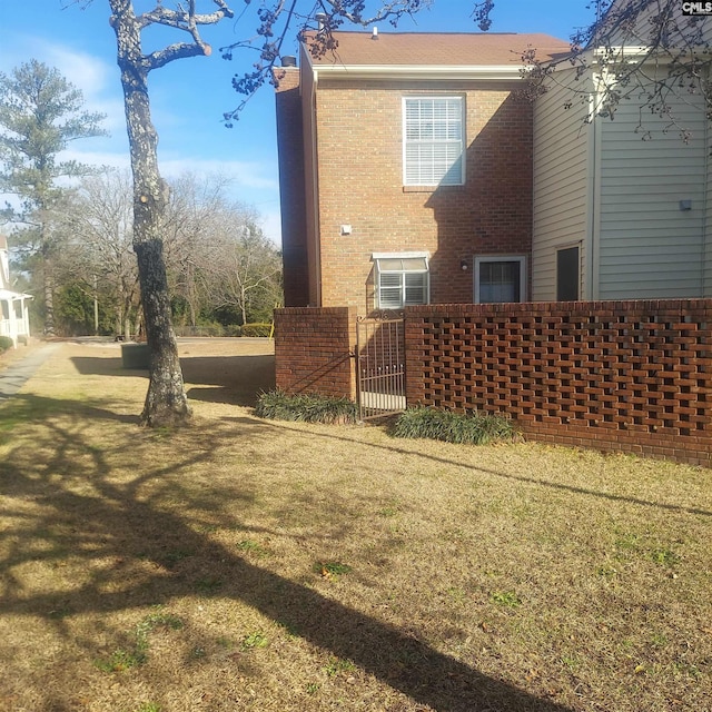 rear view of house featuring a lawn