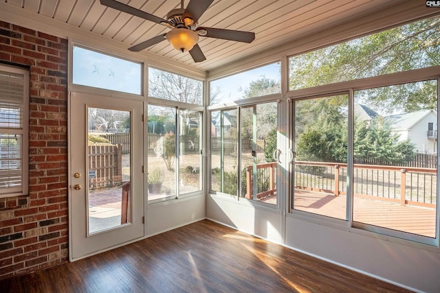 unfurnished sunroom featuring wooden ceiling and ceiling fan