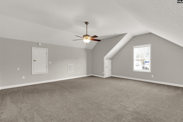 bonus room with lofted ceiling, ceiling fan, a textured ceiling, and carpet