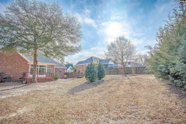 view of yard with a wooden deck and central AC unit