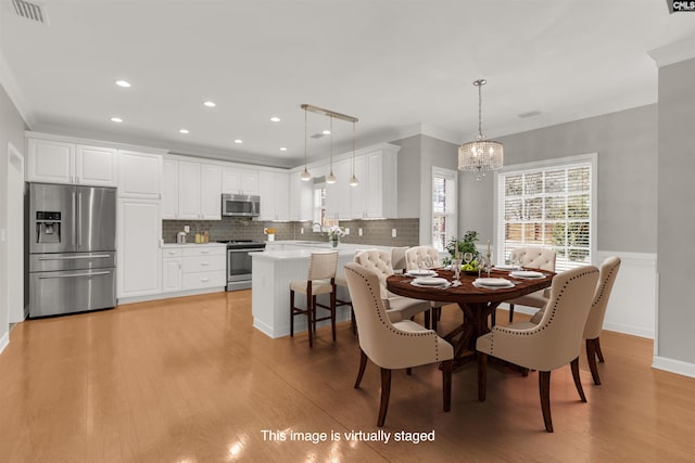 241 Highgrove Cir, West Columbia, SC 29170 - dining space with a chandelier, light wood-style flooring, crown molding, and recessed lighting
