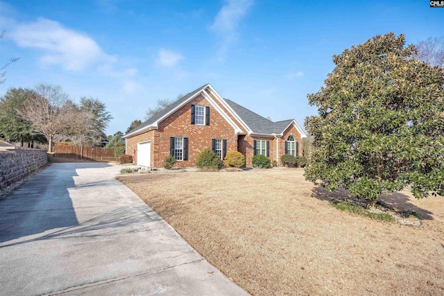 view of front of house with a garage and a front yard