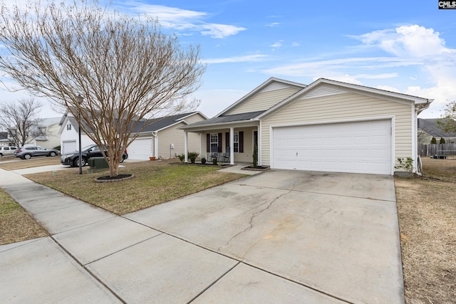 ranch-style home featuring a garage, covered porch, and a front yard