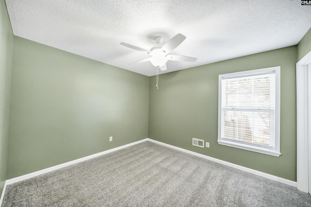 spare room featuring carpet flooring, a textured ceiling, and ceiling fan