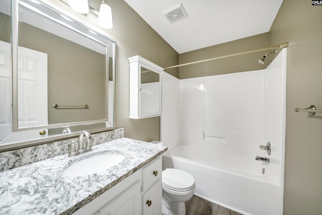 full bathroom featuring vanity, hardwood / wood-style floors, tub / shower combination, and toilet