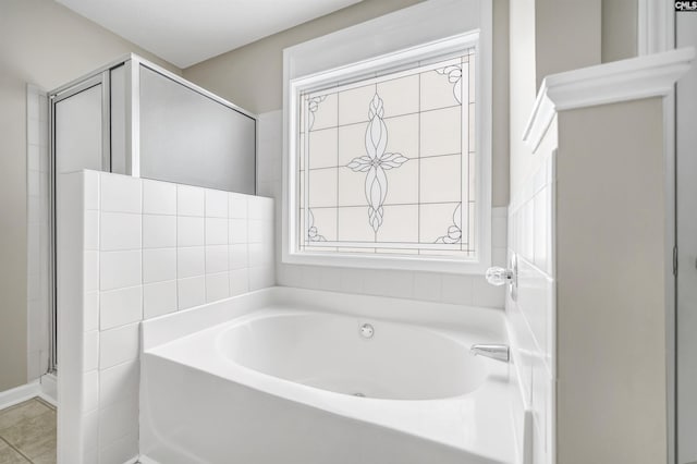 bathroom featuring tile patterned floors and separate shower and tub