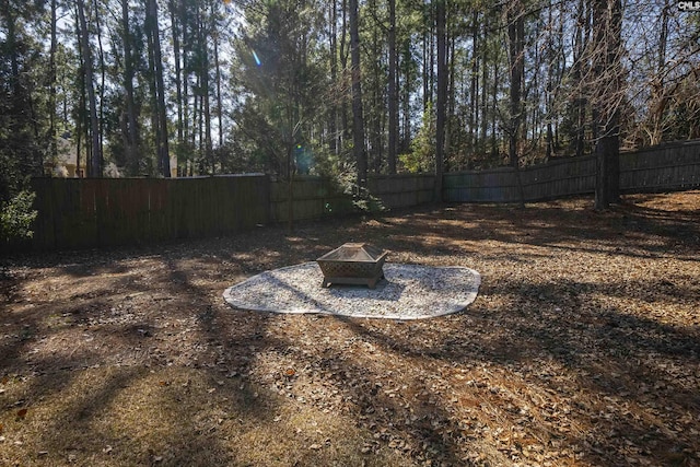 view of yard with an outdoor fire pit