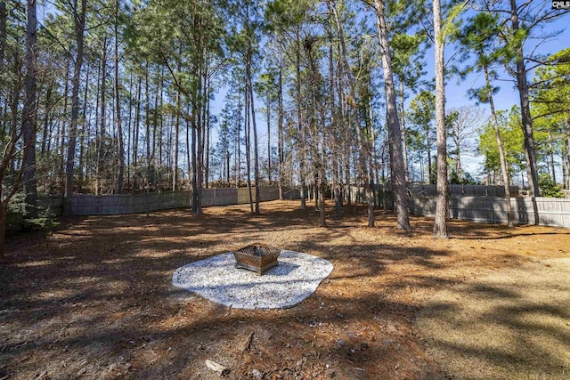 view of yard with a fire pit