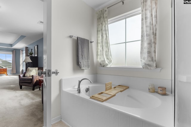 bathroom featuring a relaxing tiled tub