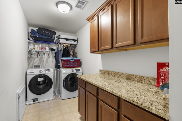 laundry area featuring cabinets and separate washer and dryer