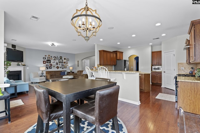 dining room featuring a notable chandelier and dark hardwood / wood-style flooring