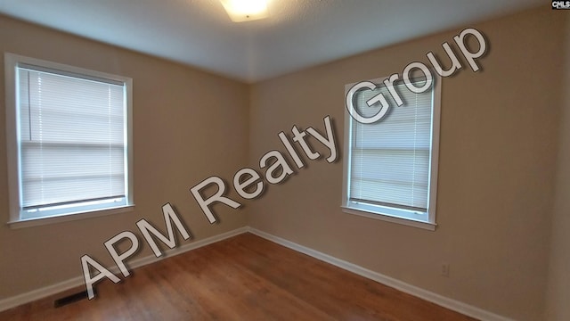 empty room featuring wood-type flooring