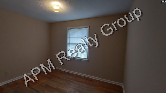 spare room featuring dark hardwood / wood-style floors