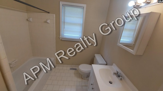 full bathroom with vanity, tiled shower / bath, tile patterned floors, and toilet