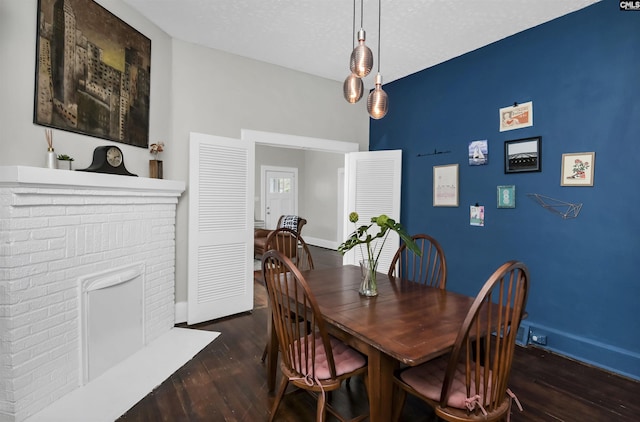 dining room with dark hardwood / wood-style floors and a textured ceiling