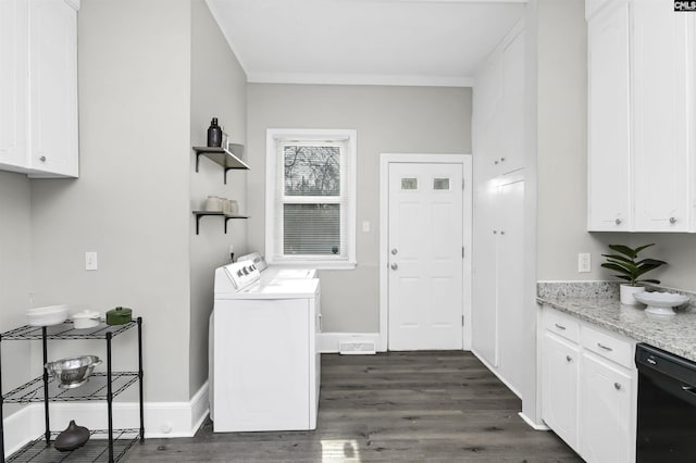 clothes washing area featuring washing machine and clothes dryer, ornamental molding, and dark hardwood / wood-style floors