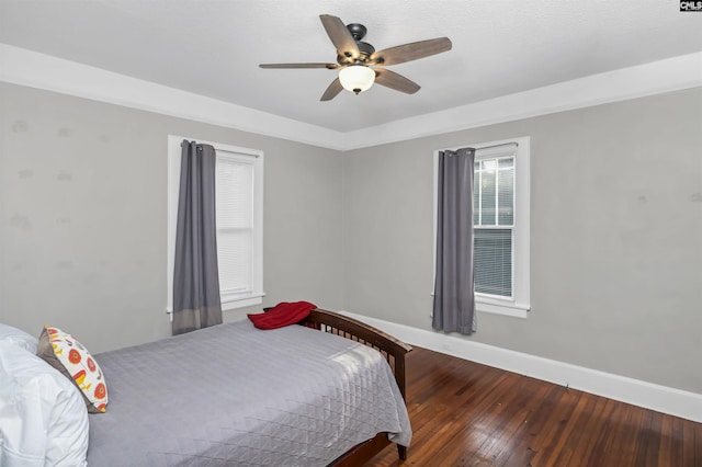 bedroom with hardwood / wood-style flooring and ceiling fan