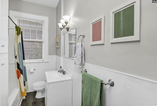 full bathroom with hardwood / wood-style flooring, an inviting chandelier, vanity, toilet, and shower / bath combo with shower curtain