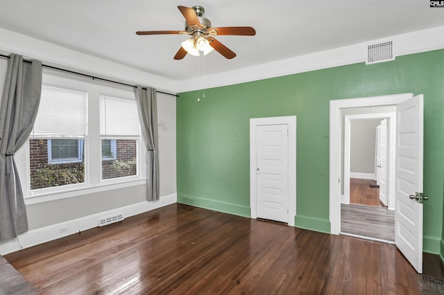 unfurnished bedroom featuring ceiling fan and dark hardwood / wood-style flooring