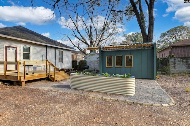 rear view of house featuring a deck