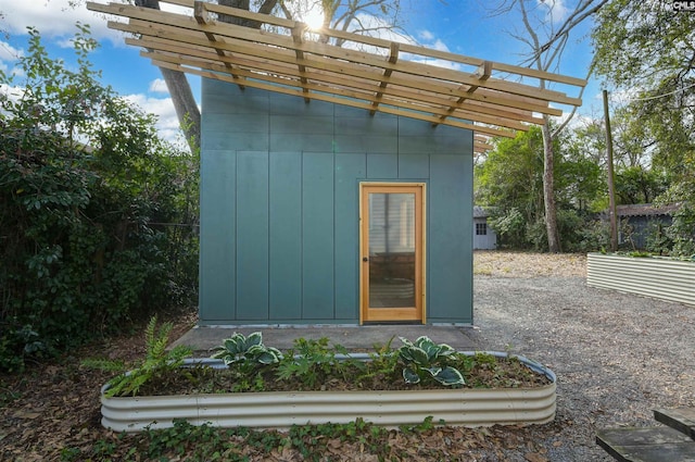 view of outbuilding with a pergola