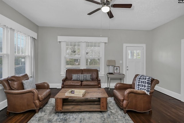 living room with dark hardwood / wood-style floors and ceiling fan